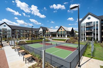Stadium-style multi-court pickleball facility with tiered seating, wet bar, firepits, and tvs
